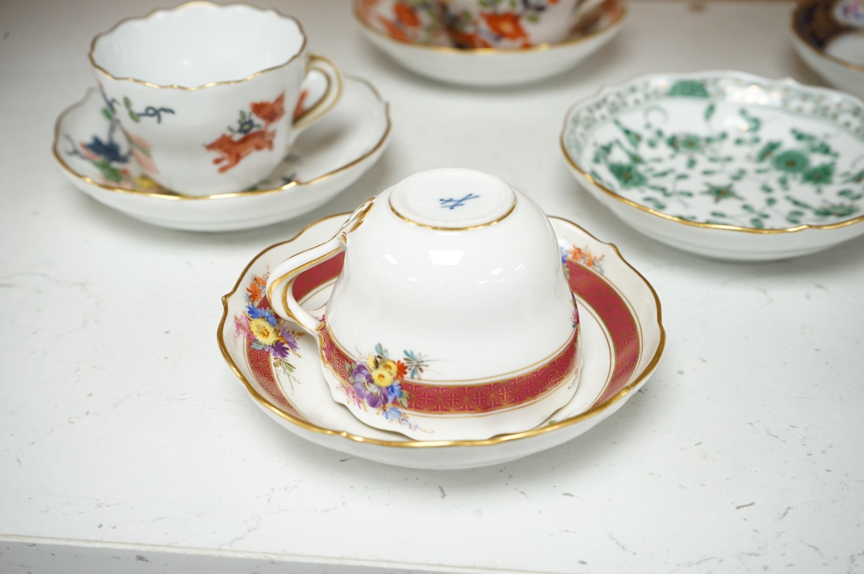 A collection of Meissen cabinet cups and saucers and four knife rests. Condition - varies